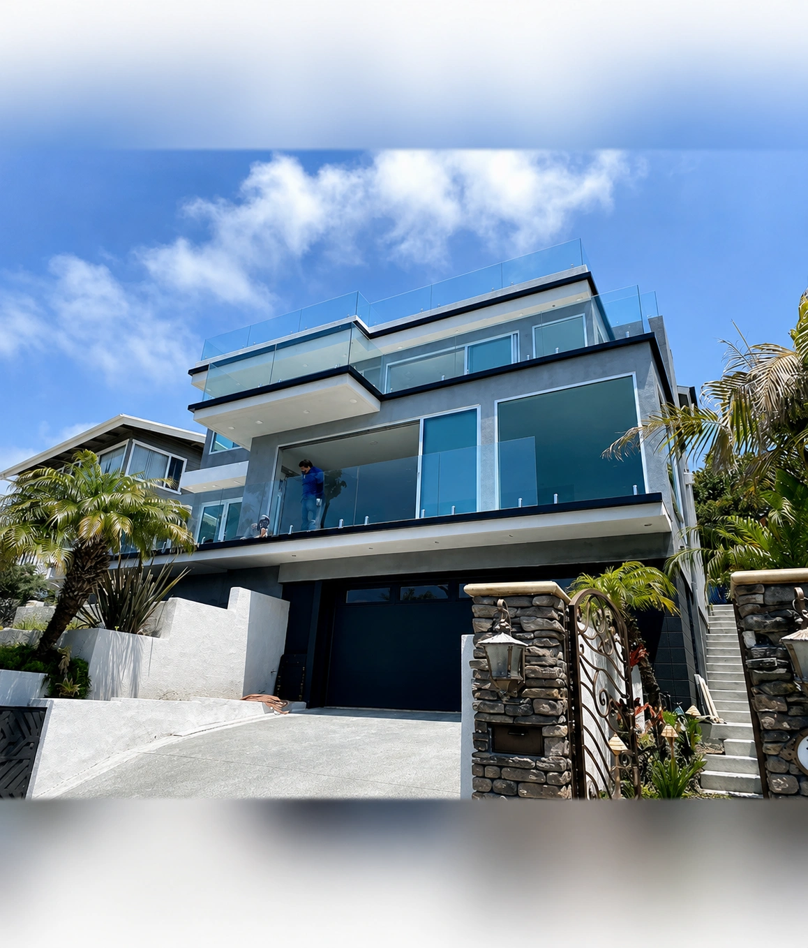Modern house with glass balconies and stairs.