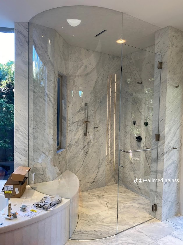 Luxury marble shower with glass enclosure.