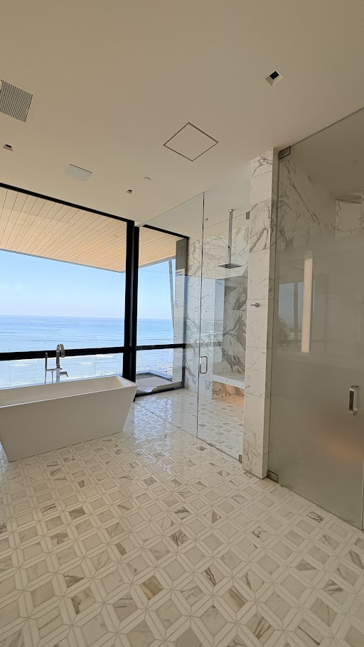 Modern bathroom with ocean view and bathtub.